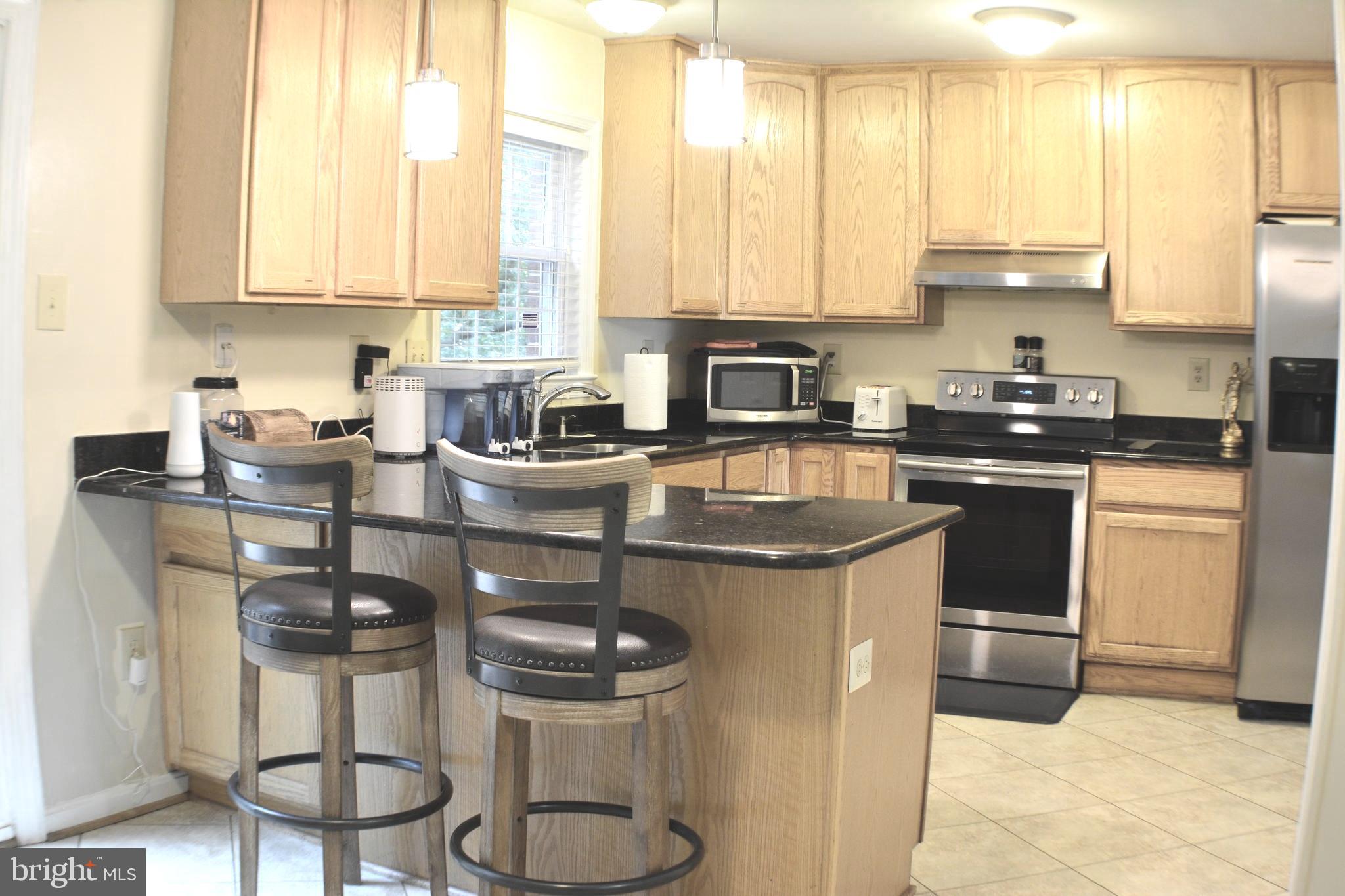 8054 Powderbrook Lane Springfield, VA 22153 - Photo 5 of 29 Granite and tile floor in kitchen