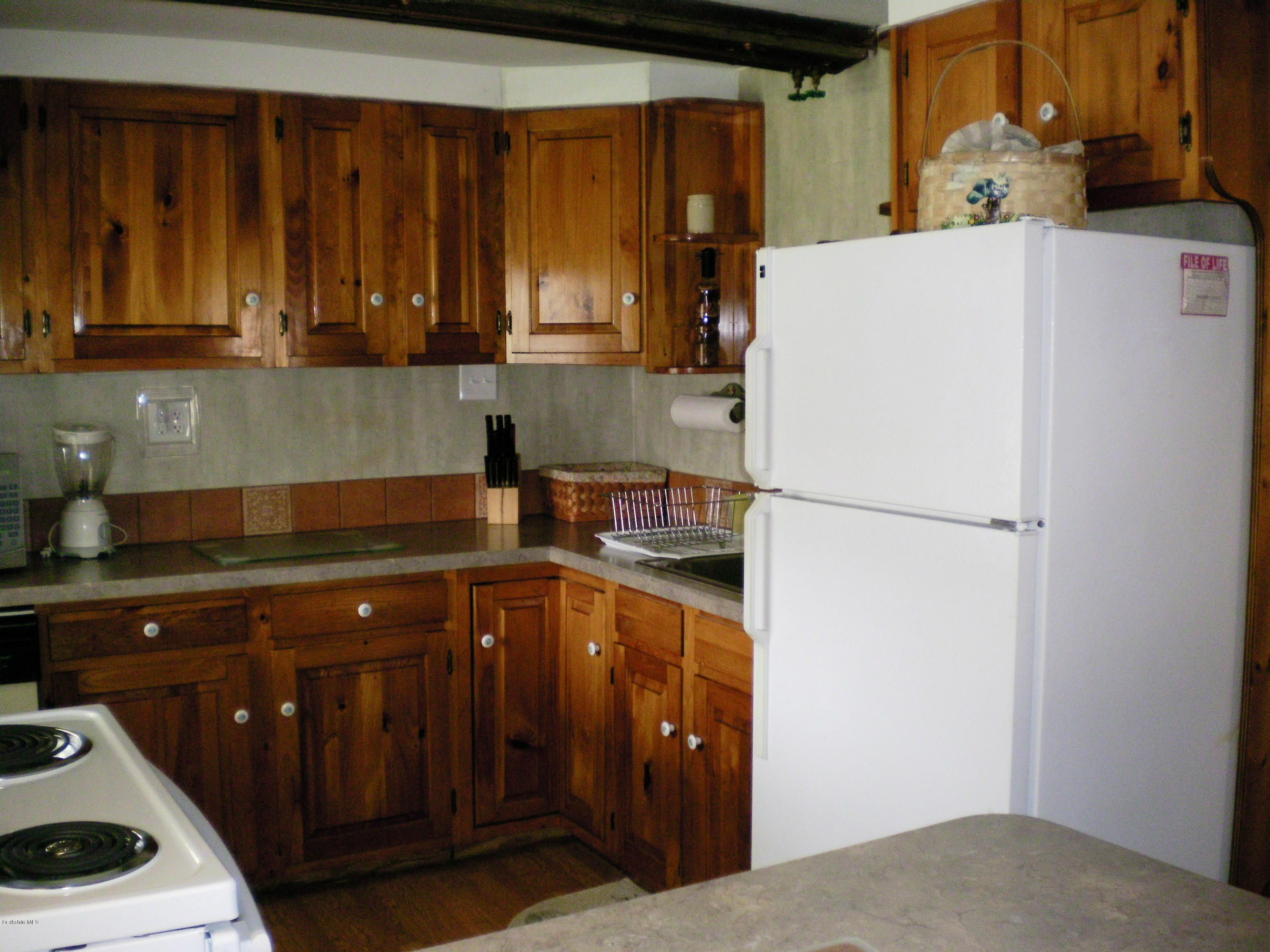 104 Middlefield Road Peru, MA 01235 - Photo 18 of 29 a kitchen with a sink a refrigerator and cabinets