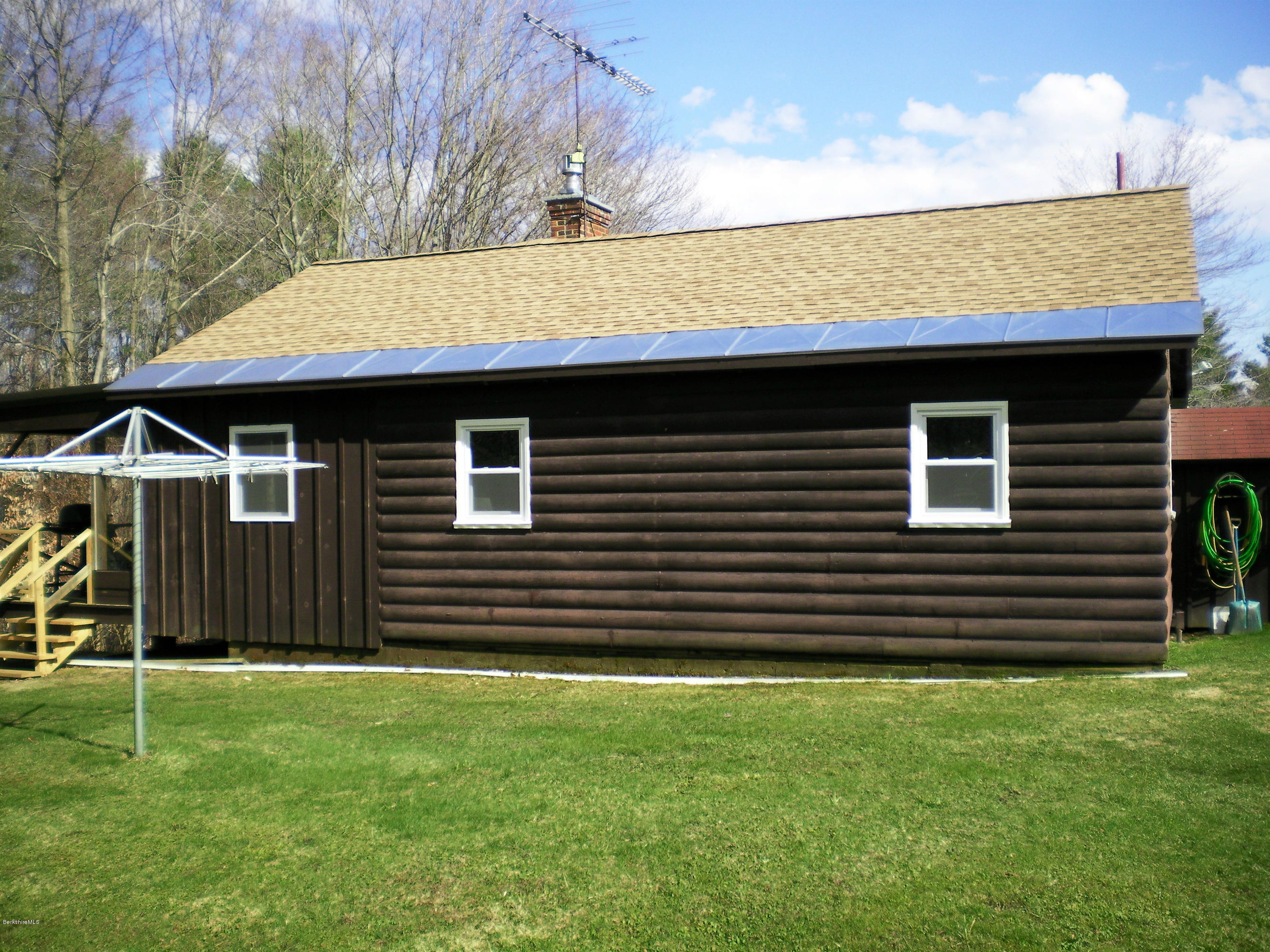 104 Middlefield Road Peru, MA 01235 - Photo 5 of 29 a front view of a house with a garden