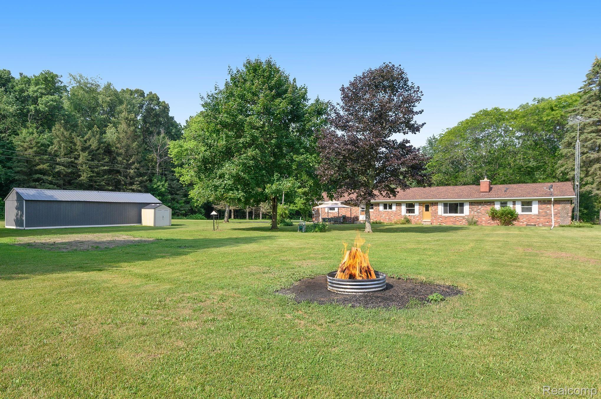 5440 Green Road Fenton, MI 48430 - Photo 29 of 44 Back view of Home & Firepit.jpg