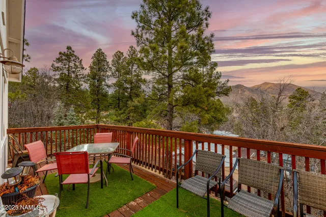 a view of a chair and table on the deck