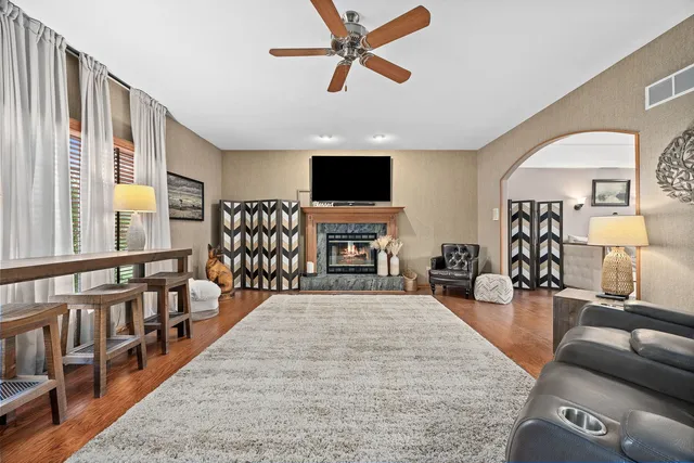 a living room with furniture fireplace and flat screen tv