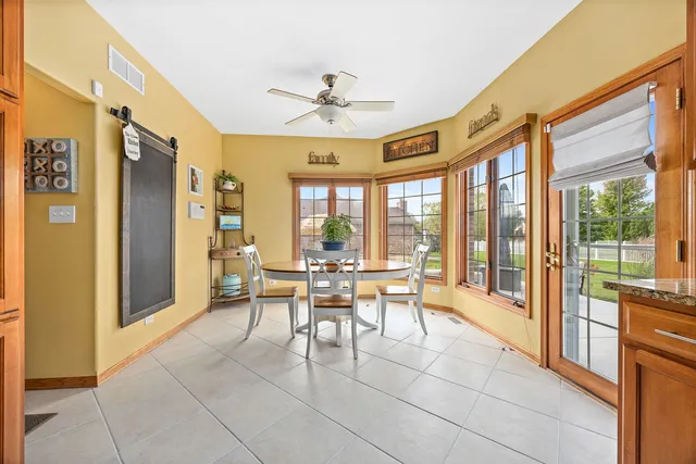 a dining room with furniture a chandelier and fireplace