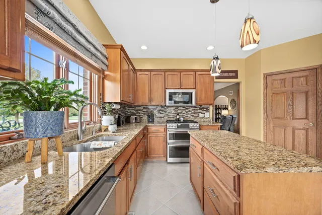 a kitchen with a stove top oven sink and cabinets