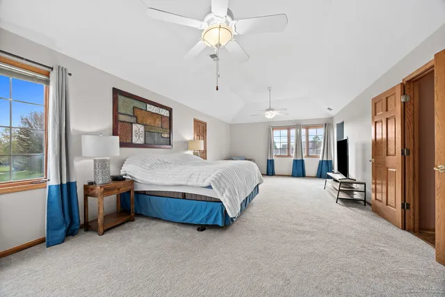 a bedroom with a bed dresser and a window