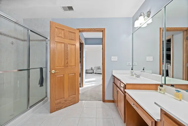 a bathroom with a sink double vanity and a mirror