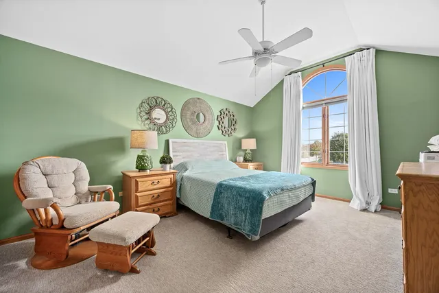 a bedroom with a bed and a chair