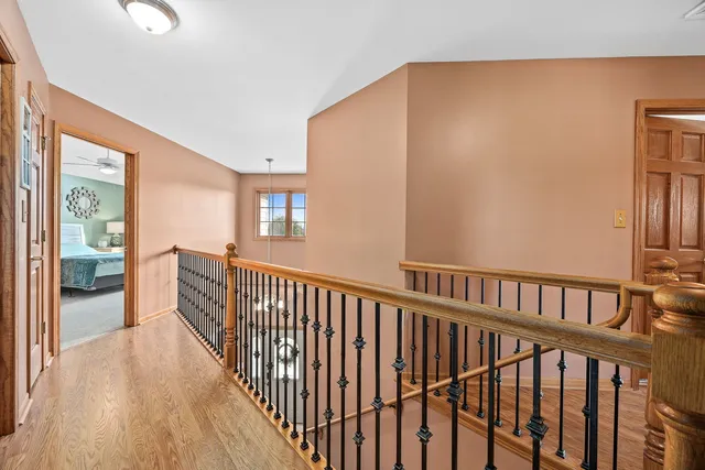 a view of hallway with wooden floor
