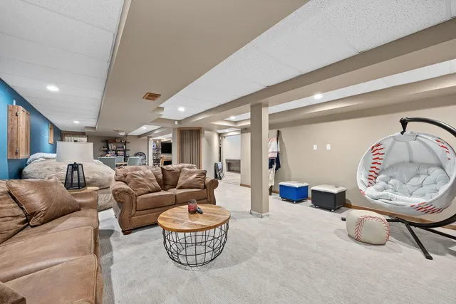 a living room with furniture a rug and kitchen view