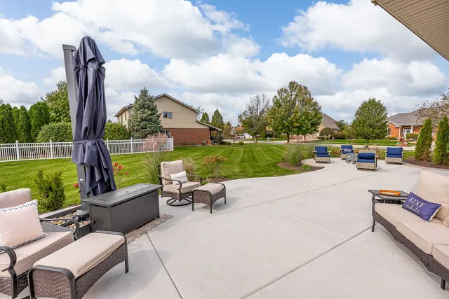 a view of a patio with swimming pool and furniture