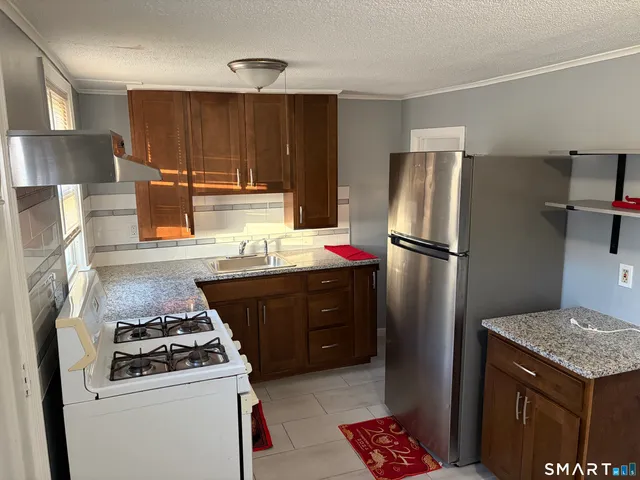 a kitchen with a stove and a refrigerator