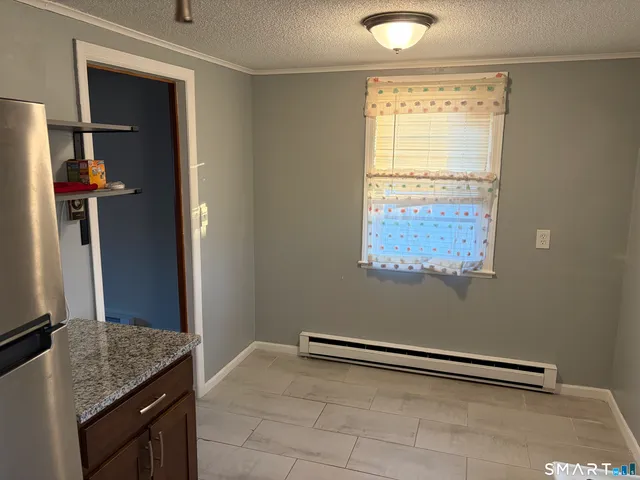 a kitchen with granite countertop a sink cabinets and a window