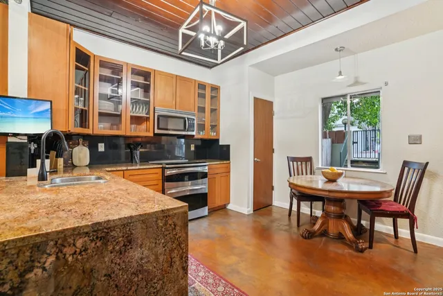a kitchen with a stove a sink and a refrigerator