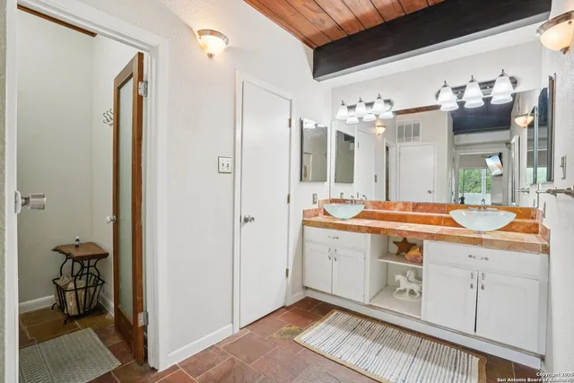 a spacious bathroom with a double vanity sink and a mirror