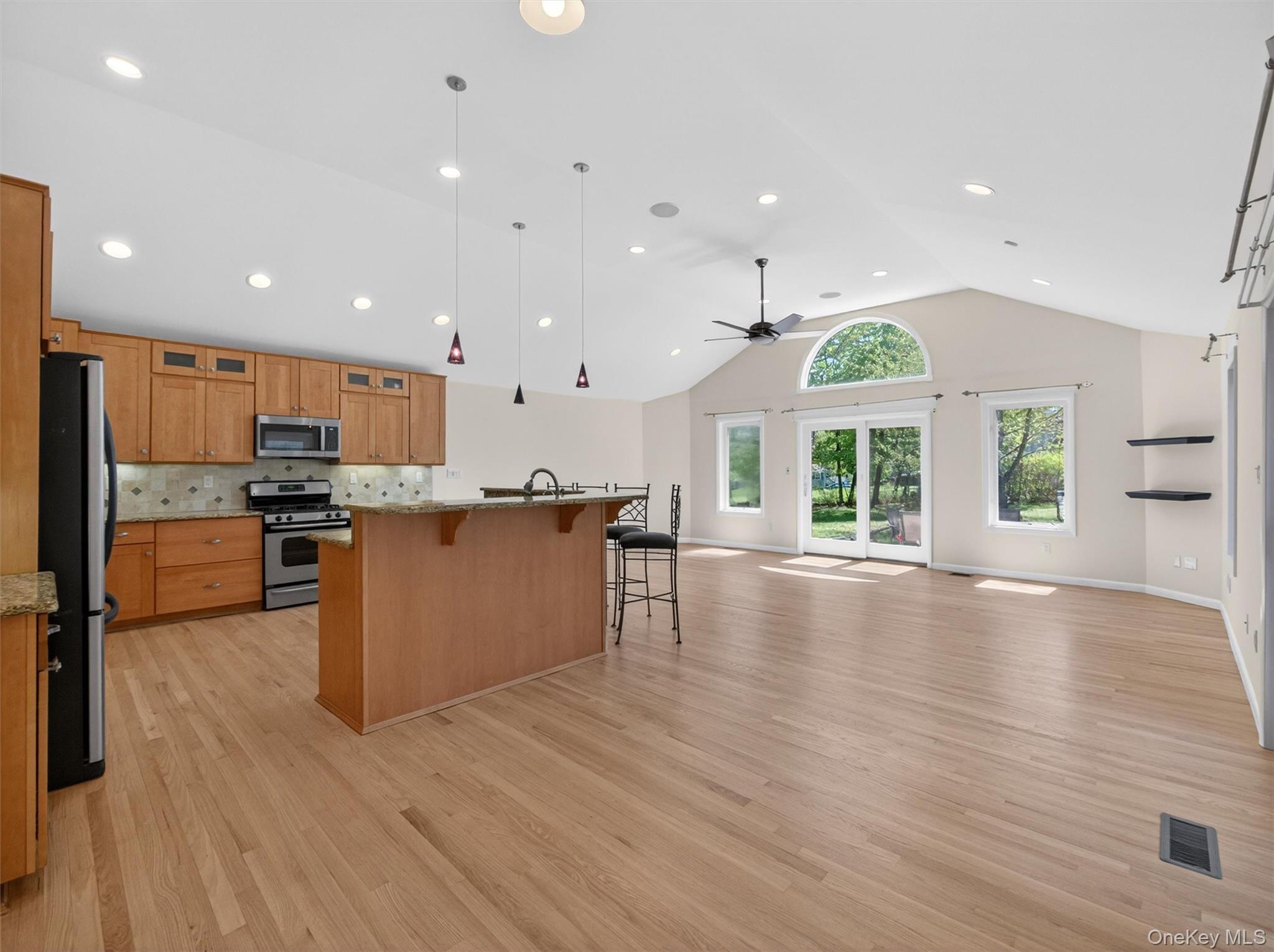 19 Buckingham Road Nanuet, NY 10954 - Photo 13 of 39 Expansive great room with sliding glass doors leading outside, offering a bright and connected space that opens beautifully to the kitchen.