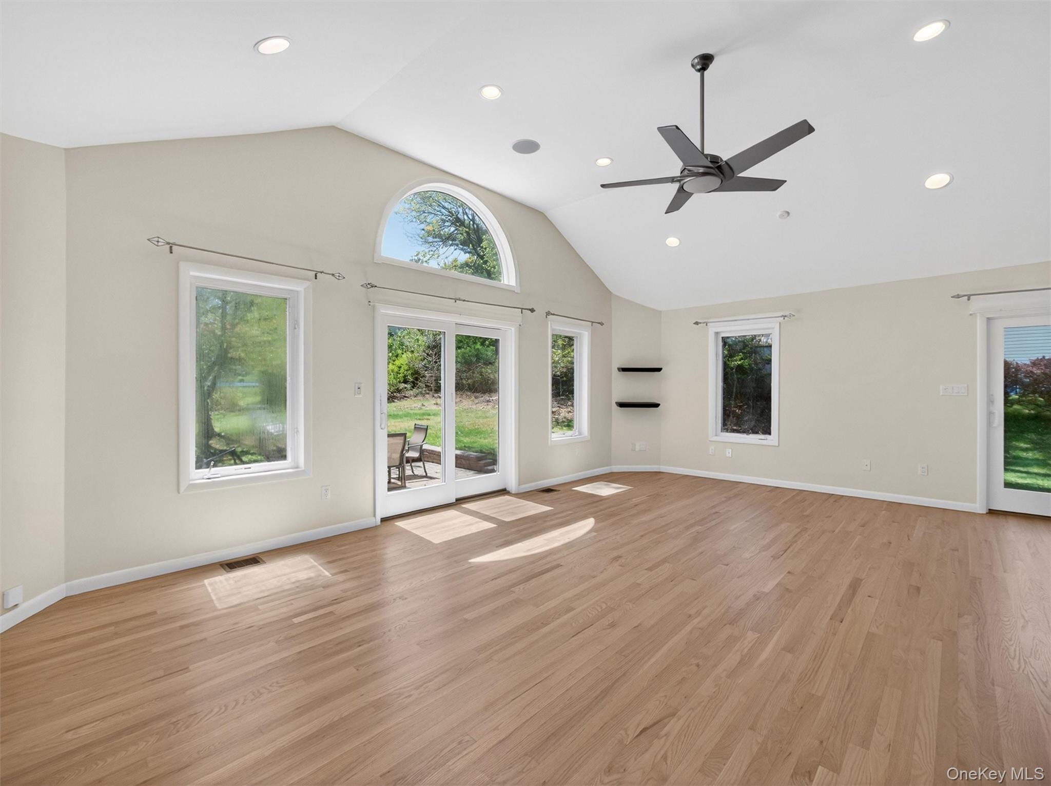 19 Buckingham Road Nanuet, NY 10954 - Photo 14 of 39 Spacious family room featuring vaulted ceilings, recessed lighting, and abundant natural light for an open, airy feel.
