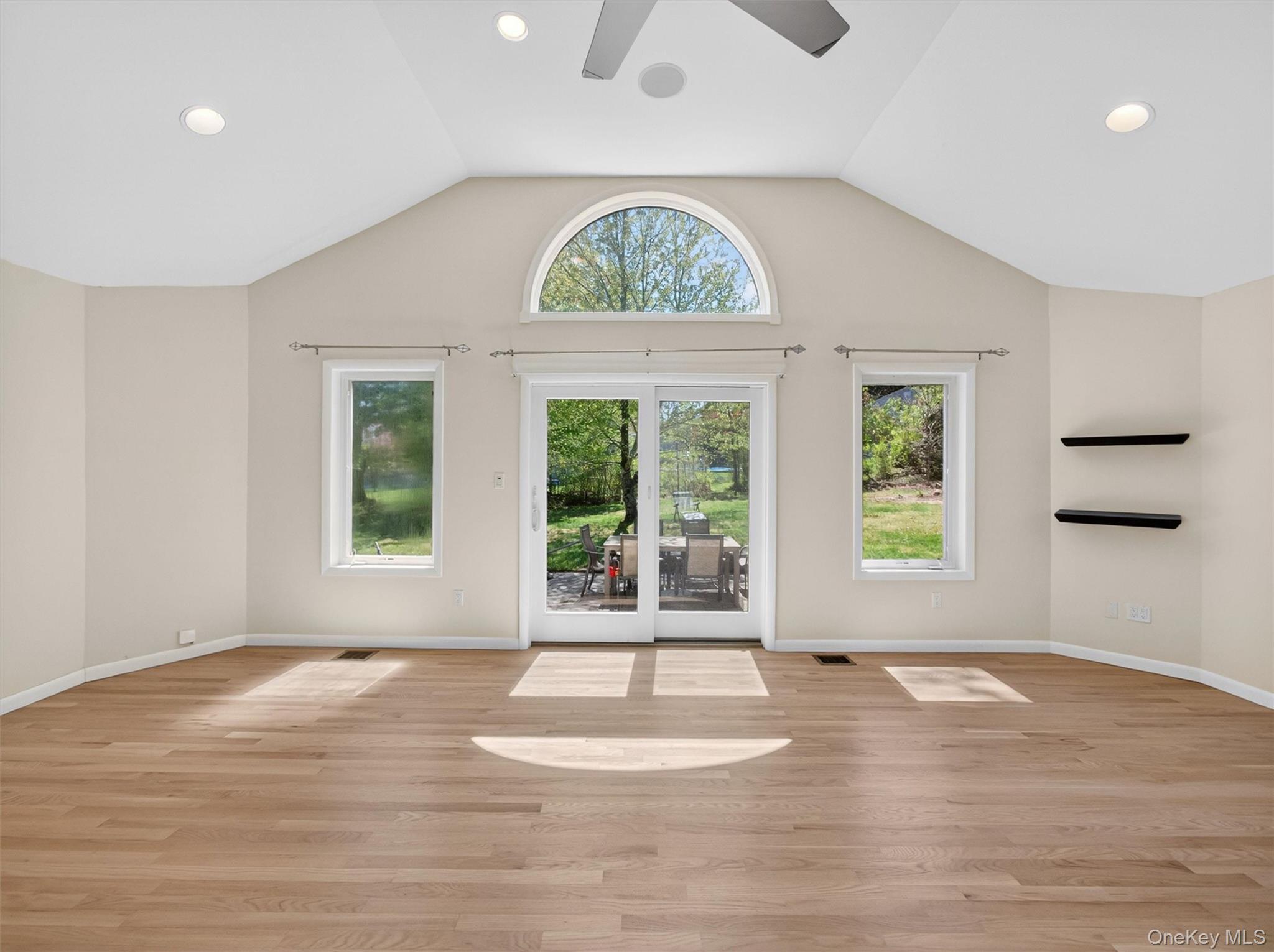19 Buckingham Road Nanuet, NY 10954 - Photo 15 of 39 Great room with sliding glass doors leading to the backyard, offering seamless indoor-outdoor living and plenty of space for entertaining.