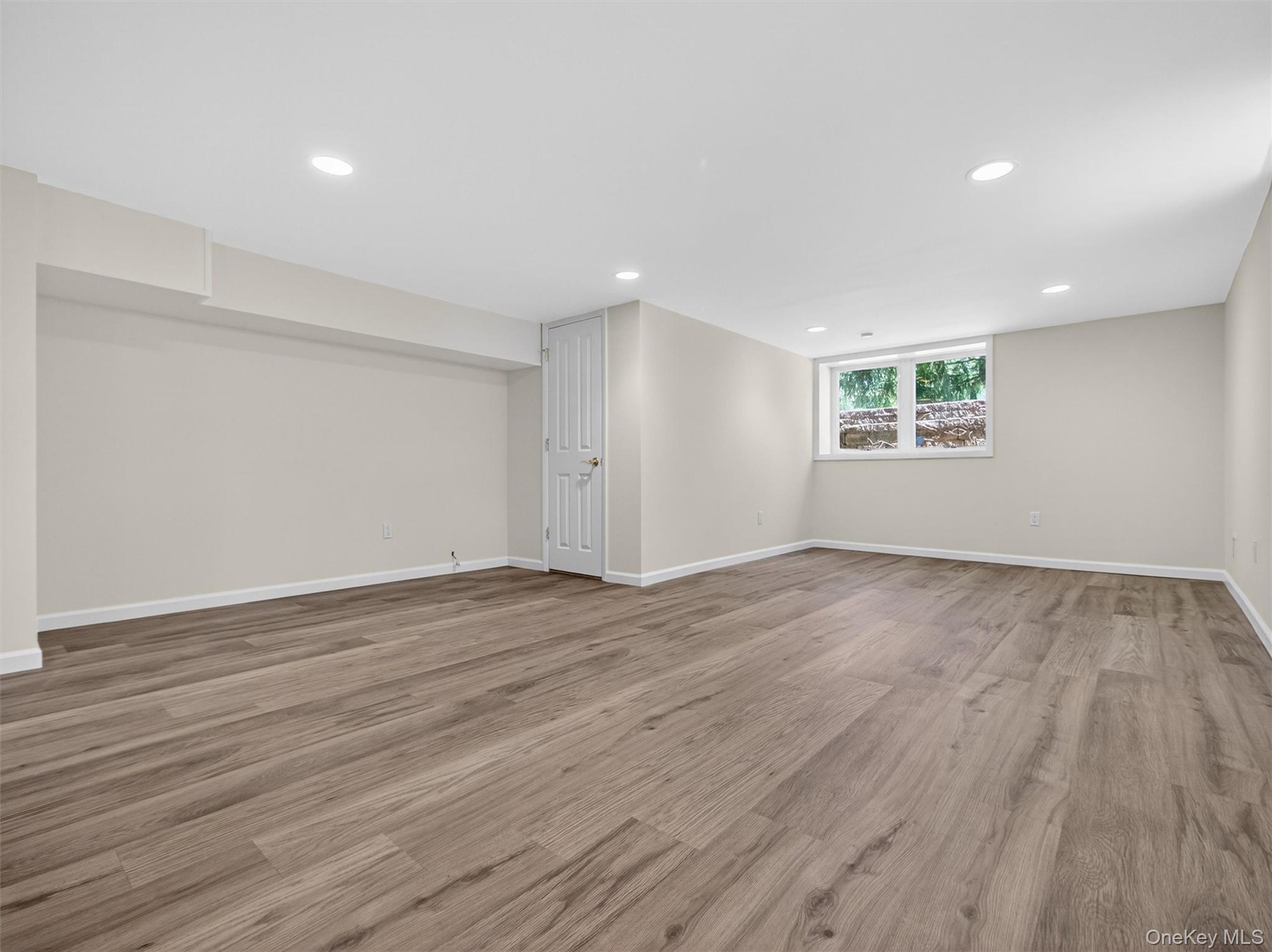 19 Buckingham Road Nanuet, NY 10954 - Photo 29 of 39 Open lower level offering flexibility for a variety of uses, enhanced by modern flooring and well-lit design.