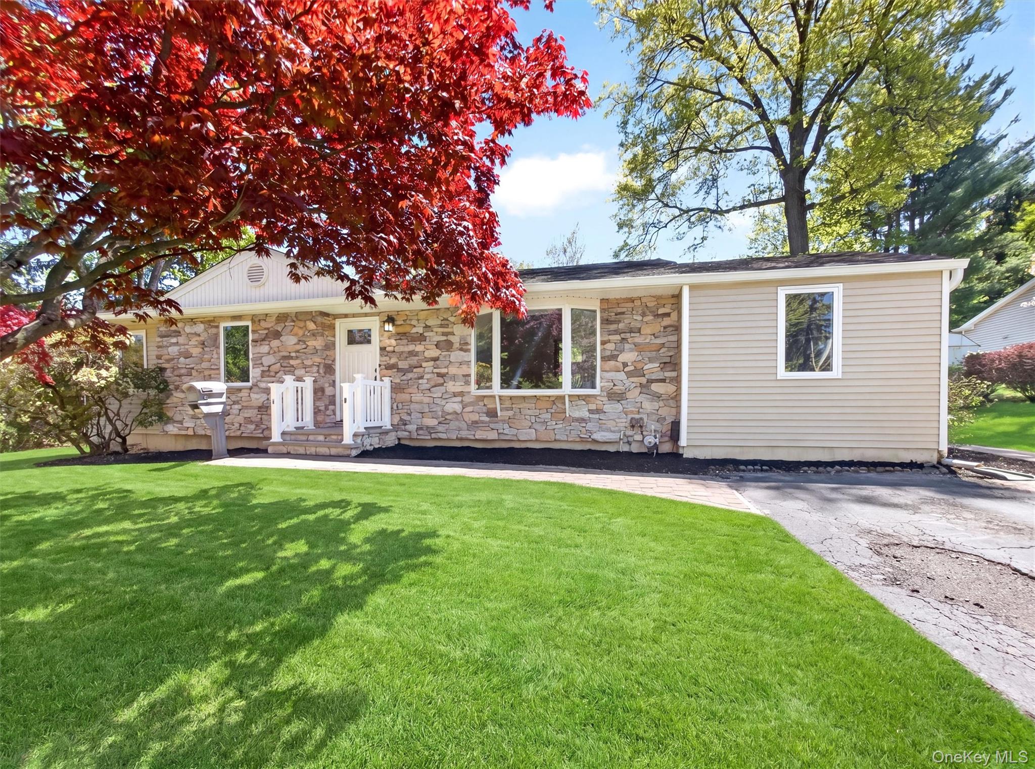19 Buckingham Road Nanuet, NY 10954 - Photo 3 of 39 Inviting curb appeal with a manicured lawn, classic brick façade, and a welcoming entry framed by mature trees.