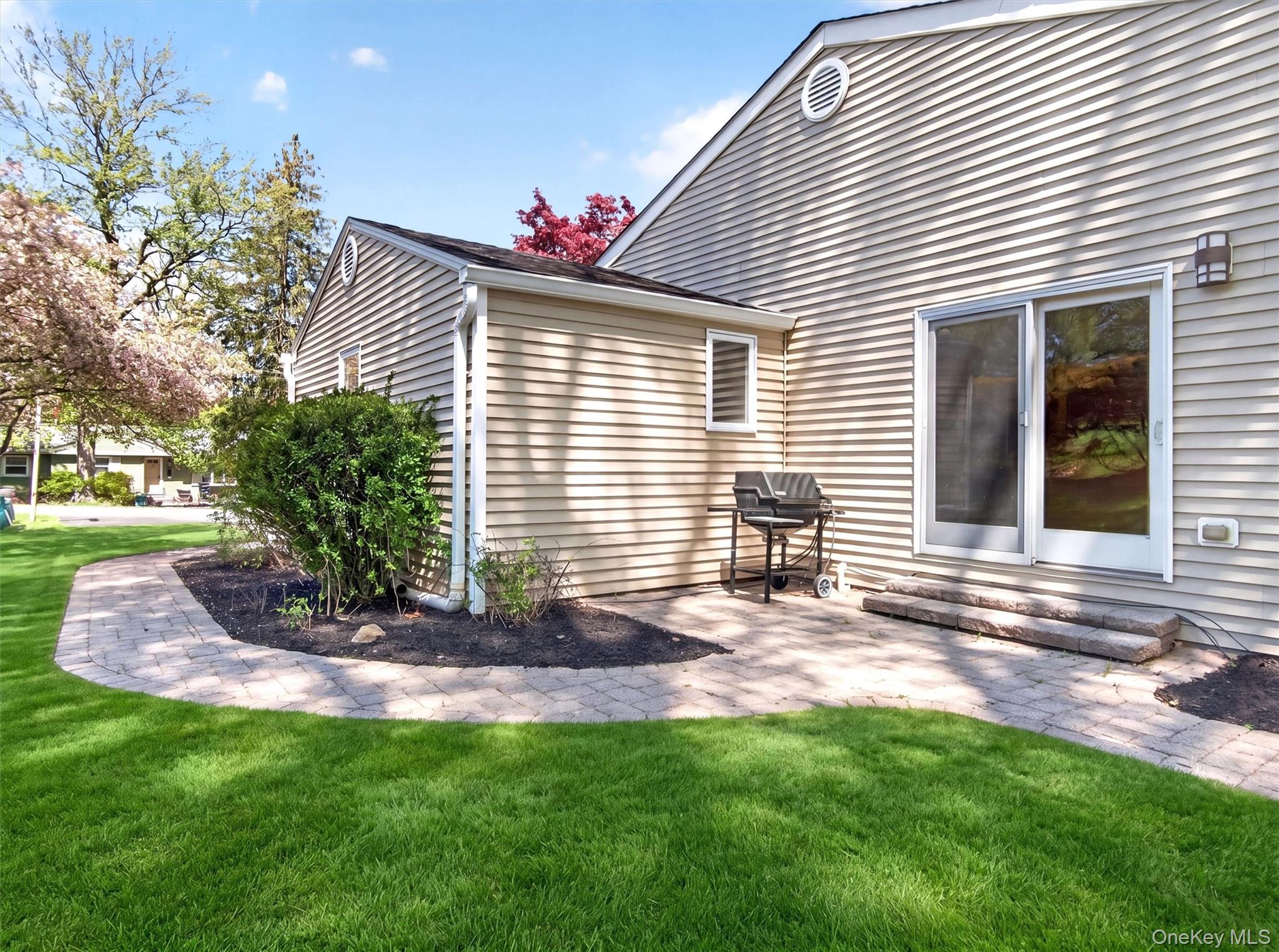 19 Buckingham Road Nanuet, NY 10954 - Photo 31 of 39 Charming side patio area with grilling space, offering easy access from sliding doors off the dining and great room areas.