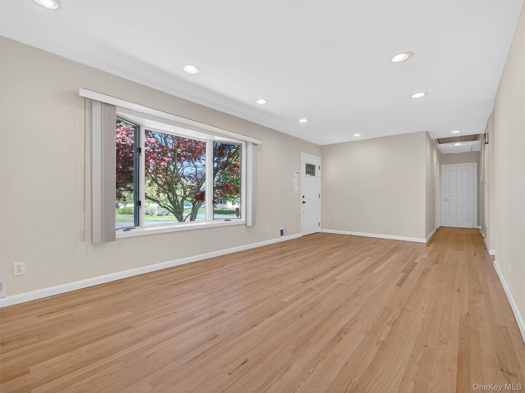 19 Buckingham Road Nanuet, NY 10954 - Photo 5 of 39 Spacious living area filled with natural light, featuring hardwood floors and a seamless flow for everyday living or entertaining.
