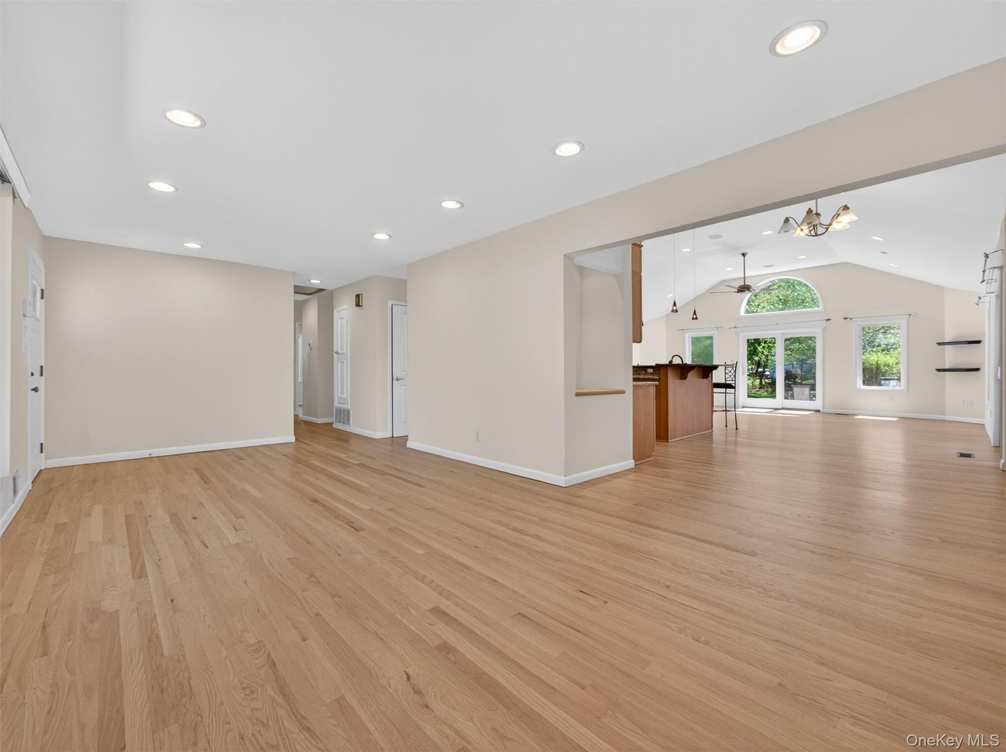 19 Buckingham Road Nanuet, NY 10954 - Photo 6 of 39 Open-concept layout highlighting the expansive space, modern lighting, and direct access to the outdoors through sliding glass doors.