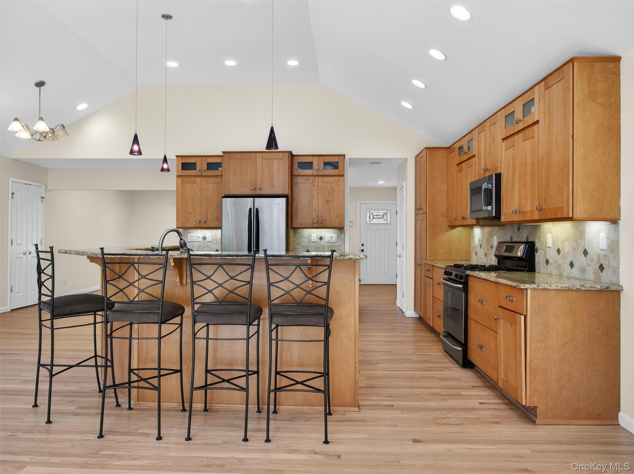 19 Buckingham Road Nanuet, NY 10954 - Photo 9 of 39 Updated kitchen featuring granite countertops, stainless steel appliances, and warm wood cabinetry with ample storage and prep space.