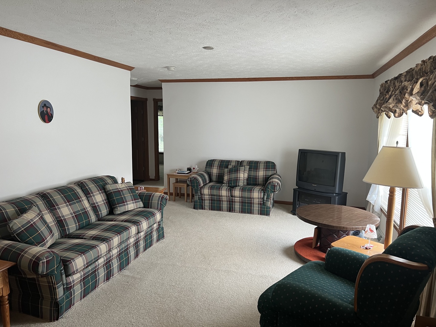 405 James Road Elwood, IL 60421 - Photo 3 of 27 a living room with furniture a lamp and a flat screen tv