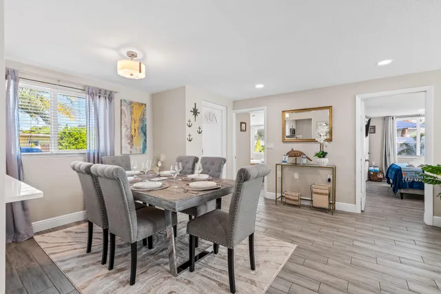 a kitchen with a refrigerator cabinets and wooden floor