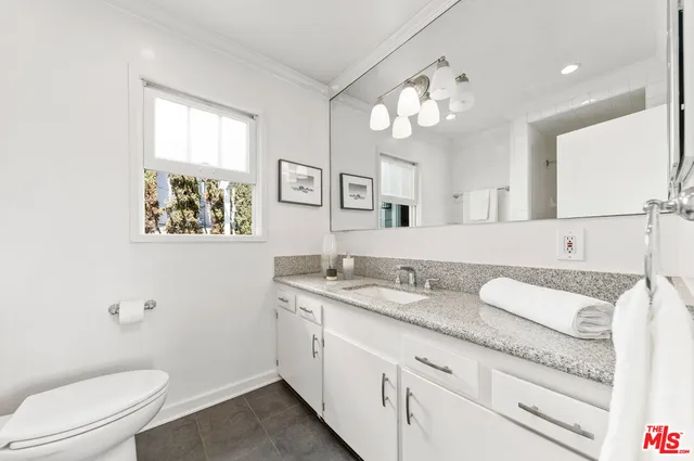 a living room with dining room and wooden floor
