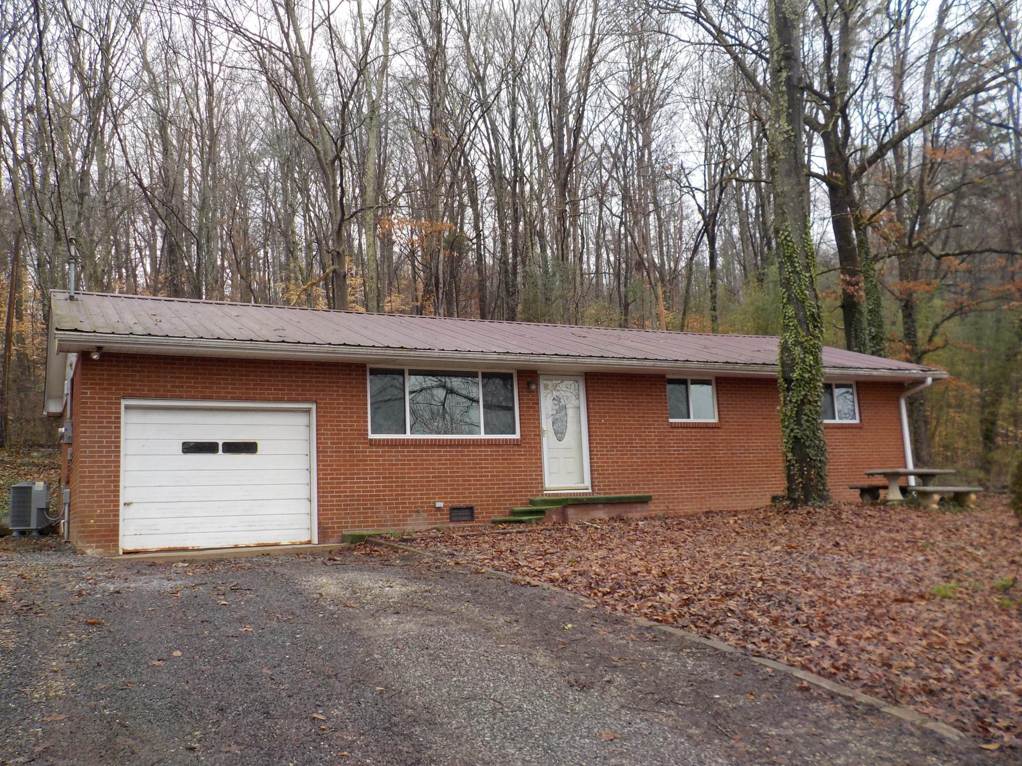 646 Edgemoor Road Powell, TN 37849 - Photo 19 of 22 a backyard of a house with large trees and a barn