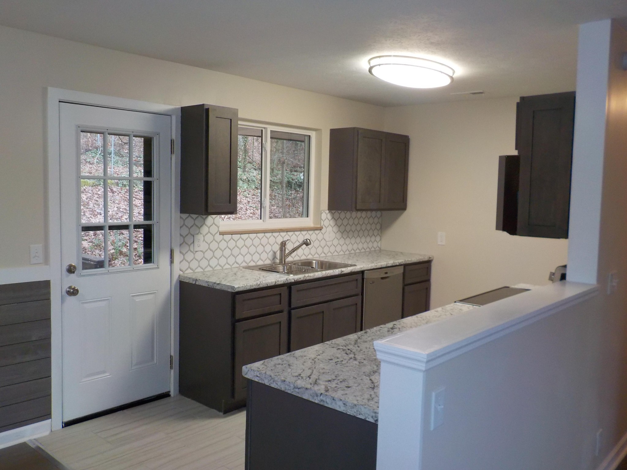 646 Edgemoor Road Powell, TN 37849 - Photo 2 of 22 a bathroom with a granite countertop sink a mirror a and a window