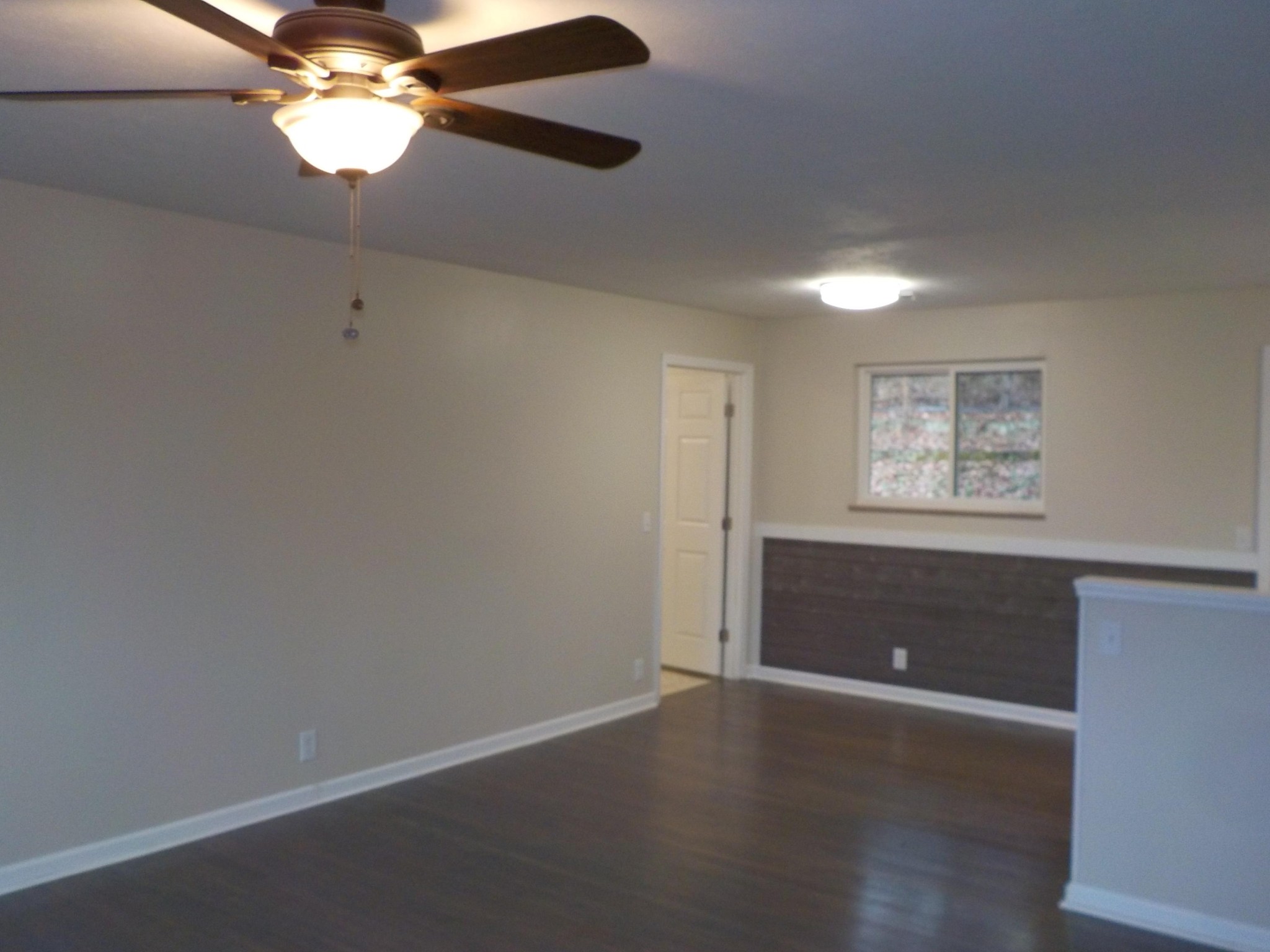 646 Edgemoor Road Powell, TN 37849 - Photo 4 of 22 an empty room with wooden floor chandelier fan and windows