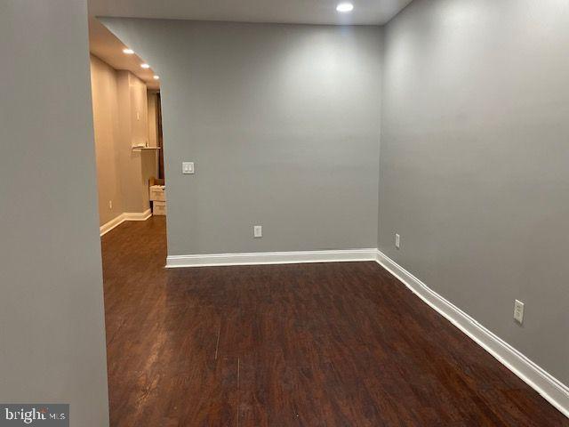 822 North Washington Street, Unit 822 Baltimore, MD 21205 - Photo 14 of 14 an empty room with wooden floor and windows