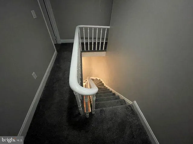 a view of empty room with windows and ceiling fan