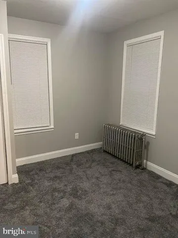 a bathroom with a granite countertop shower and a sink