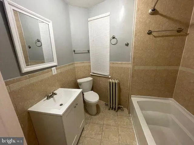 a kitchen with a stove a refrigerator and a microwave