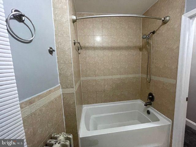 822 North Washington Street, Unit 822 Baltimore, MD 21205 - Photo 10 of 14 a bathroom with a granite countertop shower and a sink