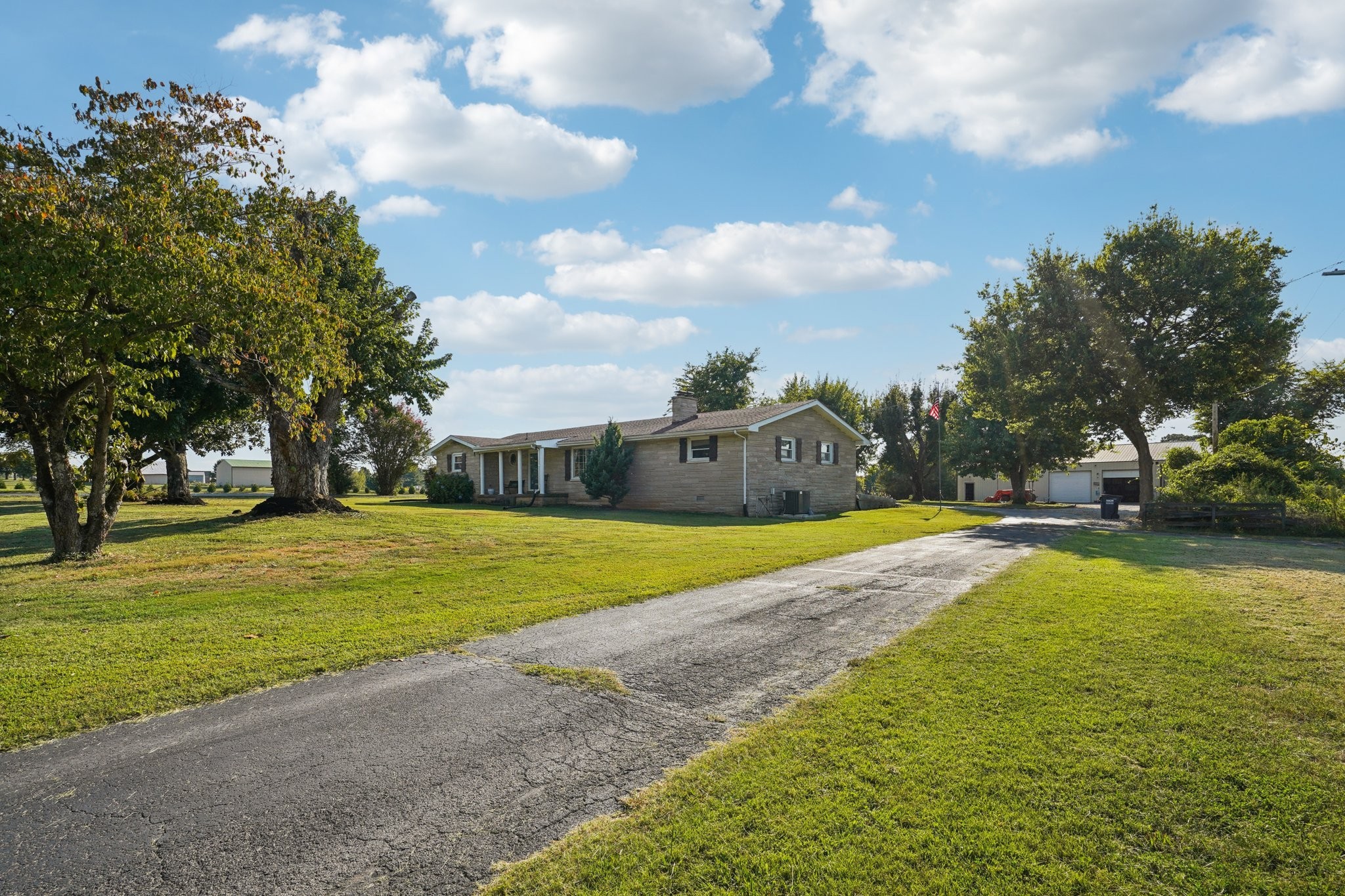 7559 Scottsville Road Lafayette, TN 37083 - Photo 4 of 42 a view of a swimming pool and trees in the background