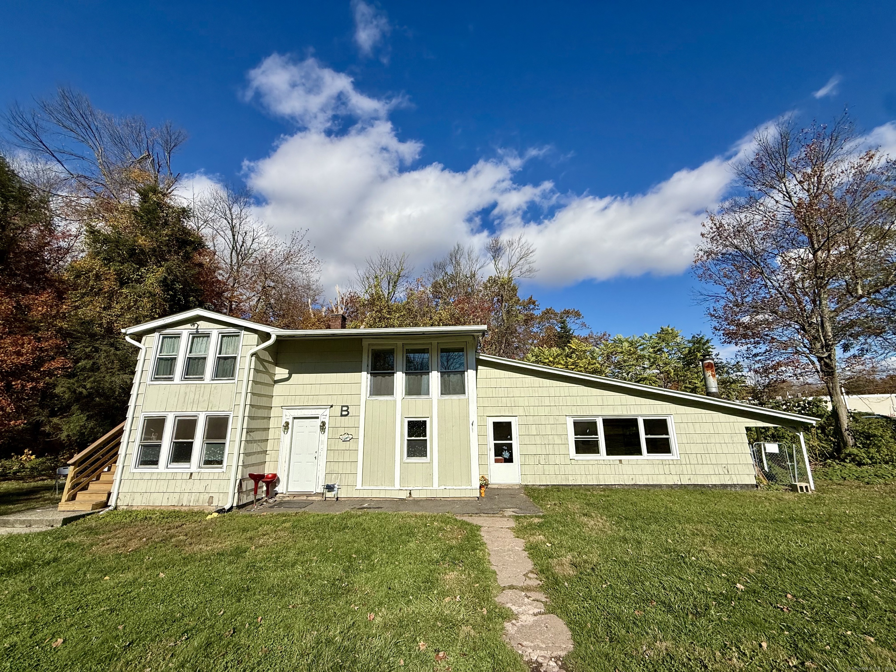 41 Waterbury Road, Unit B1 Prospect, CT 06712 - Photo 1 of 10 a front view of a house with a garden