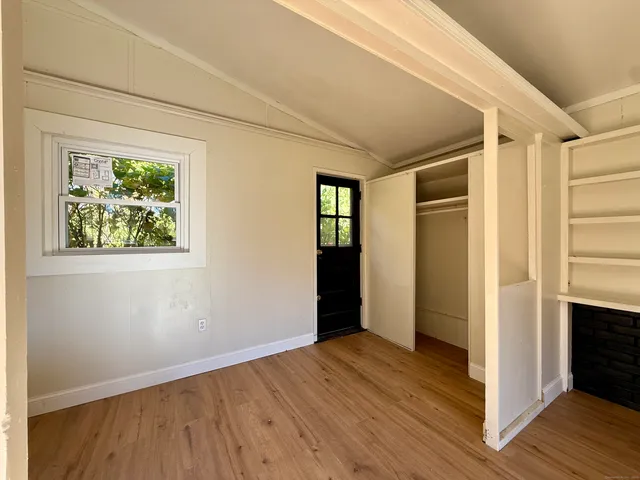 a view of hallway with wooden floor and stairs