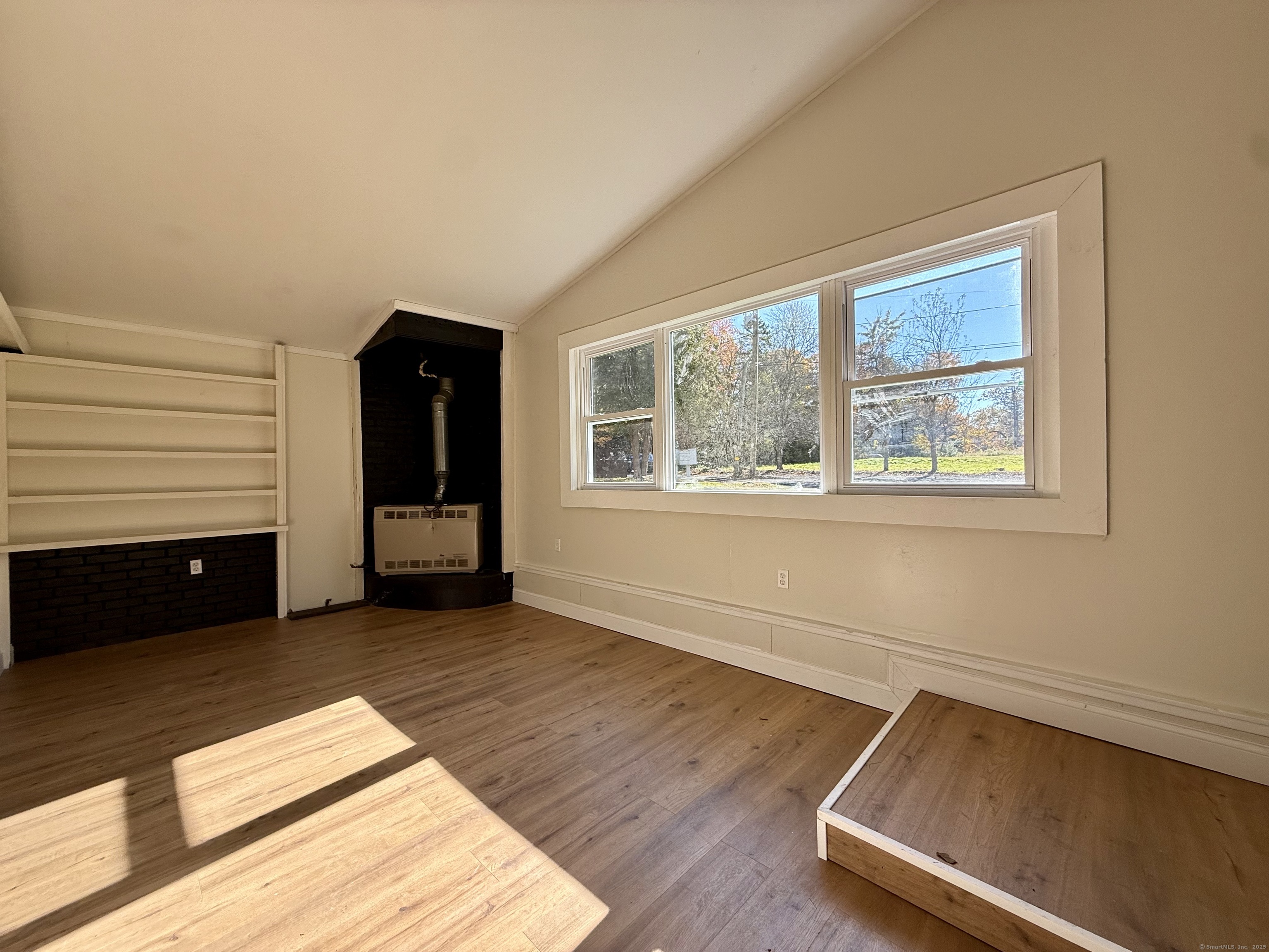 41 Waterbury Road, Unit B1 Prospect, CT 06712 - Photo 7 of 10 a view of an empty room with a window and wooden floor