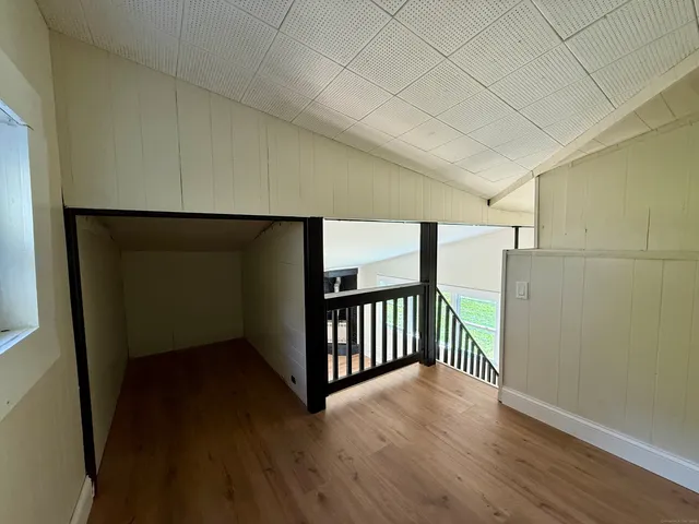 a view of hallway with wooden floor