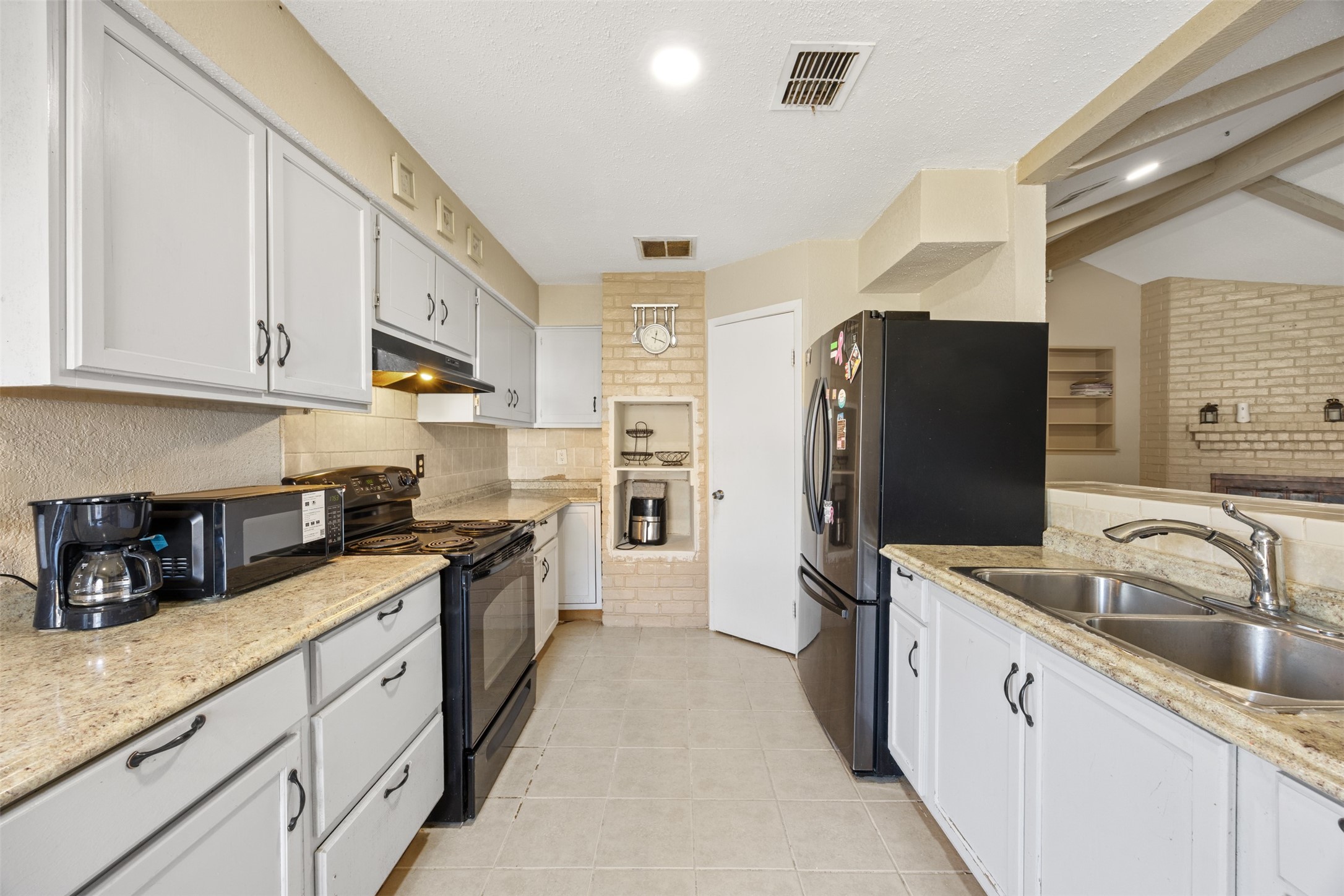 6715 Rowell Court Houston, TX 77489 - Photo 7 of 24 a kitchen with stainless steel appliances granite countertop a sink stove and refrigerator