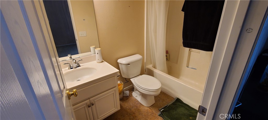 2563 Gilbert Avenue Corona, CA 92881 - Photo 13 of 21 a bathroom with a sink and a mirror