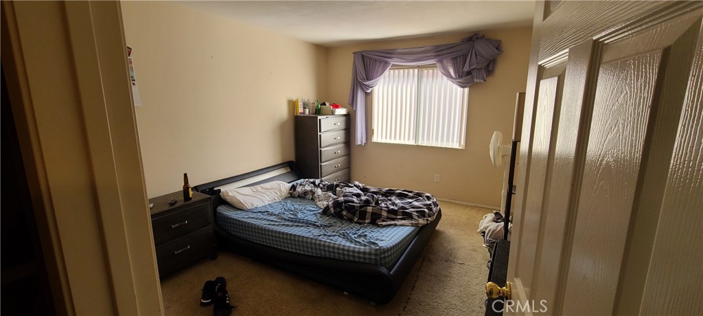 2563 Gilbert Avenue Corona, CA 92881 - Photo 20 of 21 a bed sitting in a bedroom next to a window