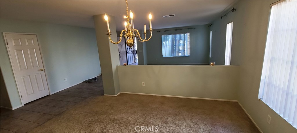 2563 Gilbert Avenue Corona, CA 92881 - Photo 3 of 21 en empty room with windows and ceiling fan