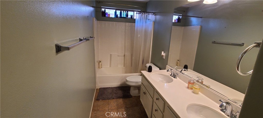 2563 Gilbert Avenue Corona, CA 92881 - Photo 10 of 21 a bathroom with a sink a toilet and shower