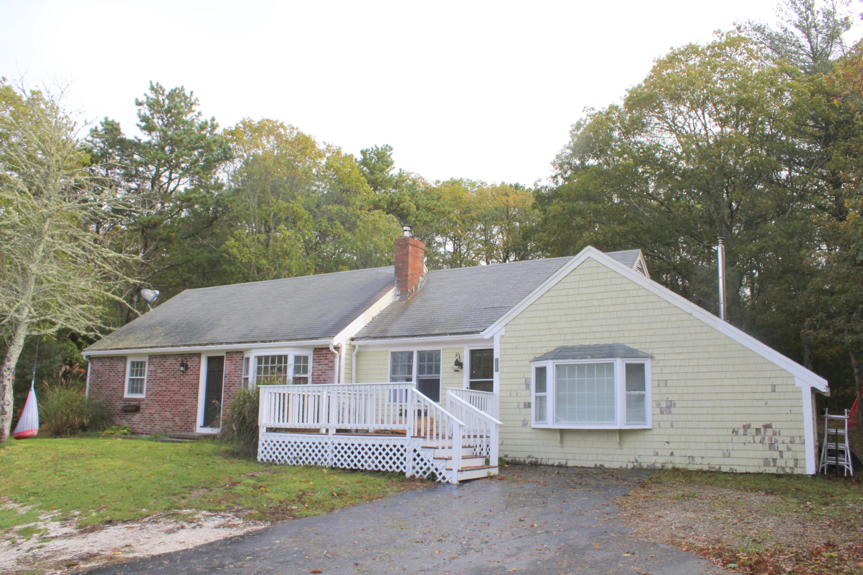 128 Turtleback Road Marstons Mills, MA 02648 - Photo 1 of 20 a view of a white house with a yard and large tree