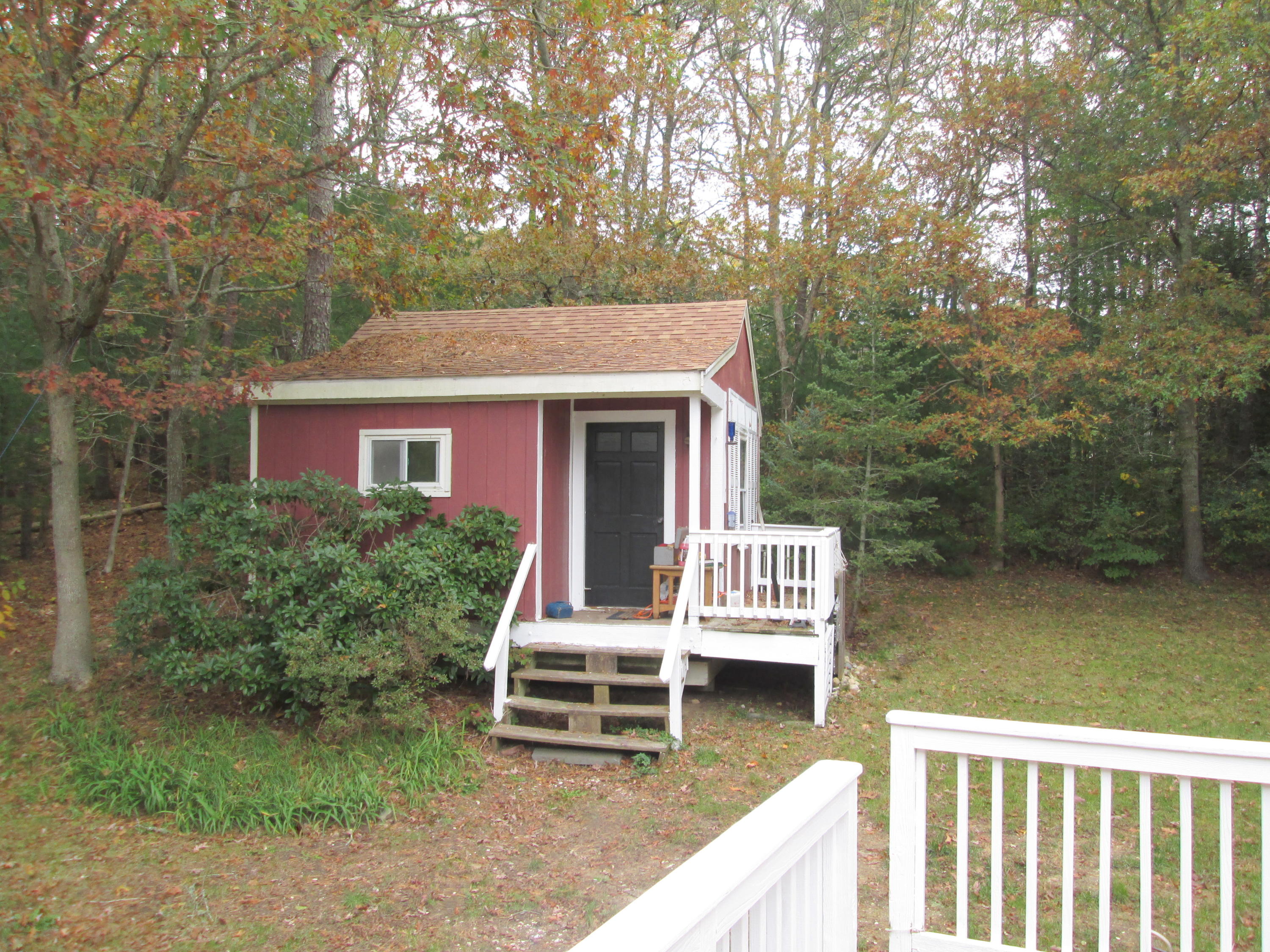 128 Turtleback Road Marstons Mills, MA 02648 - Photo 14 of 20 a balcony with table and chairs with wooden fence